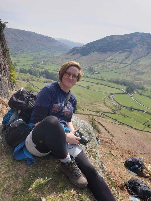 Caitlin sitting on hillside