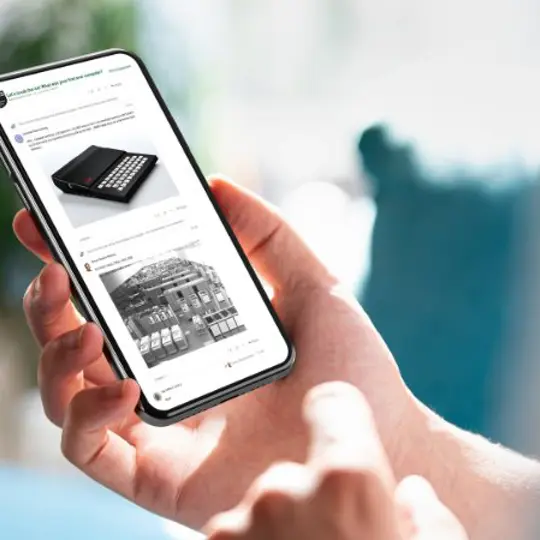 a hand holding a smartphone