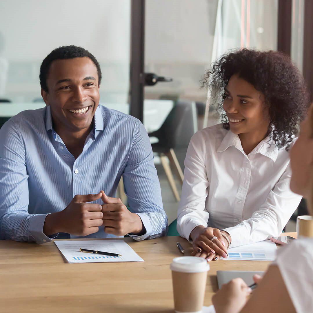 three people in a meeting space