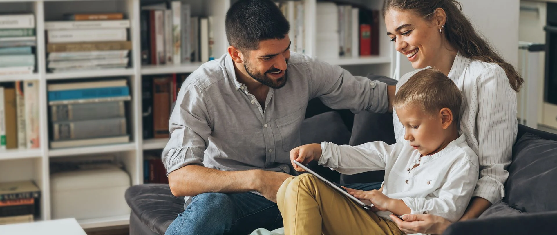A young family sharing a story together on a tablet