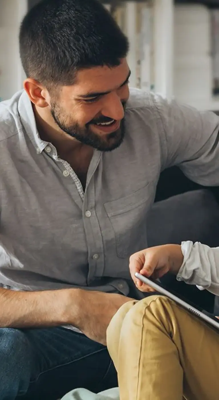 A young family sharing a story together on a tablet