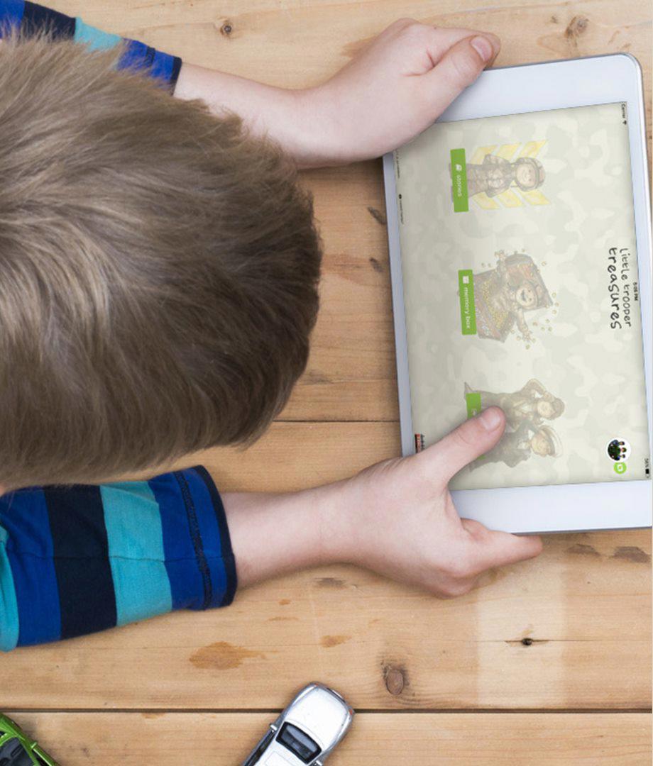 A young child enjoying an interactive story on a tablet screen