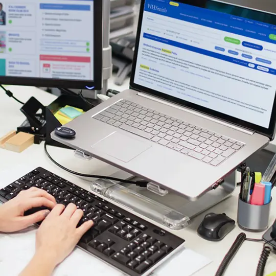 person typing on laptop