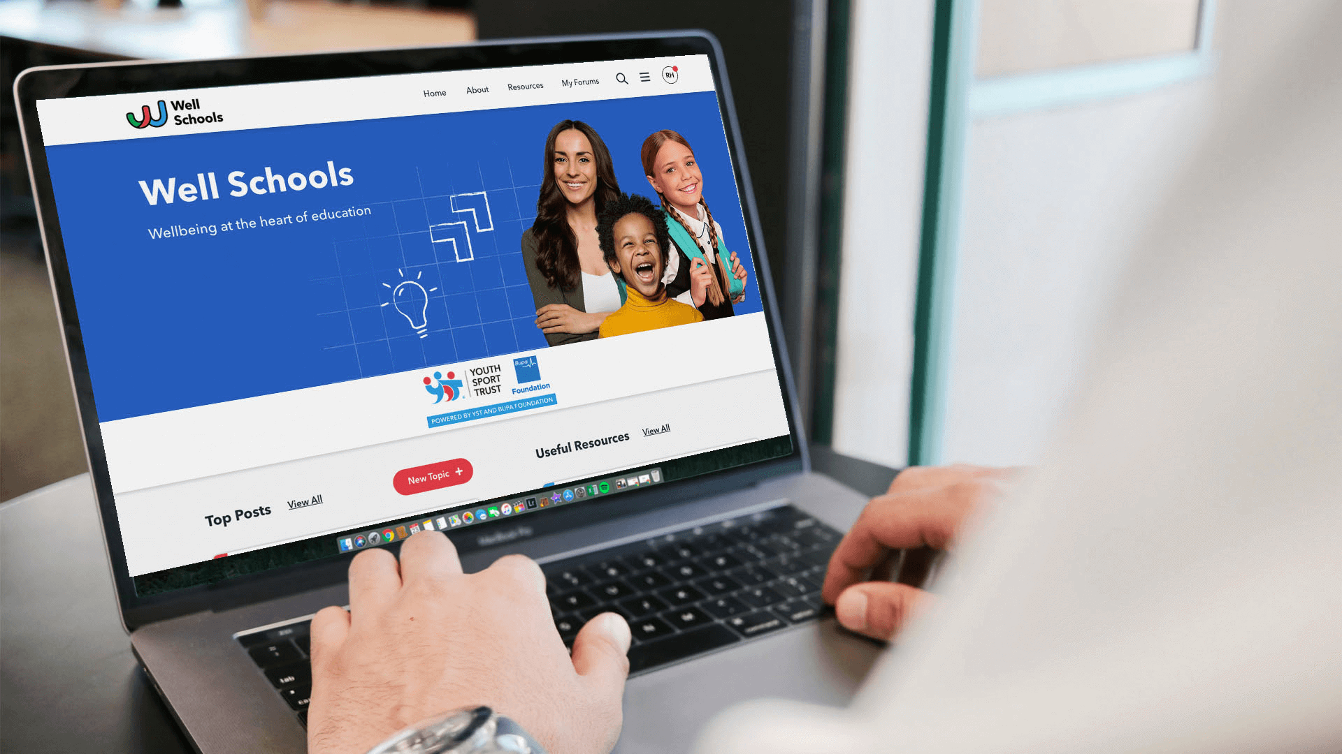Well schools homepage on a laptop screen